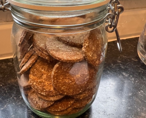 Peanut butter dog biscuits in a glass kilner jar